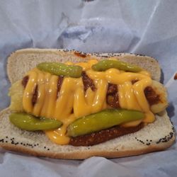 Sinisi’s On Main - Mother in Law. Tamale on poppyseed bun with sport peppers & nnall