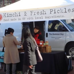 a woman selling fresh pickles