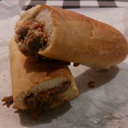 Three cheeseless, small cheesesteaks