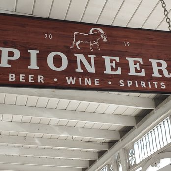Pioneer - a wooden sign hanging from the ceiling - Bars Near Me - Fredericksburg, Texas Pioneer - a wooden sign hanging from the ceiling - Bars Near Me - Fredericksburg, Texas