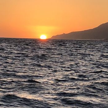 Blue Sky Cabo - The sun dips her head below the waters. - Fishing Near Me