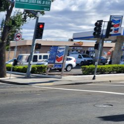 Chevron - Chevron at the corner of Lincoln and Charter Way/Dr. MLK Blvd. And bamner advertising L. Soda for $0.49 at entrance.