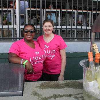 Liquid Catering - Two Liquid Catering bartenders smile for the camera at Euphoria - Caterers Near Me - Greenville, South Carolina Liquid Catering - Two Liquid Catering bartenders smile for the camera at Euphoria - Caterers Near Me - Greenville, South Carolina