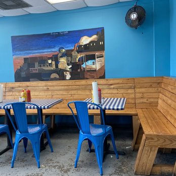 Our Place - a table with blue chairs and a painting on the wall - Breakfast & Brunch Near Me - Gardendale, Alabama Our Place - a table with blue chairs and a painting on the wall - Breakfast & Brunch Near Me - Gardendale, Alabama