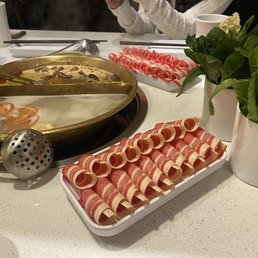two beef platters, pork bone broth, spice broth and three different greens. two beef platters, pork bone broth, spice broth and three different greens.