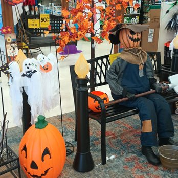 Olson's Ace Hardware - Store display - The display includes a scarecrow with a pumpkin head sitting on a bench, surrounded by Halloween-themed decorations like pumpkins, ghosts, and autumn leaves. - Hardware Stores Near Me - Franklin Park, Illinois