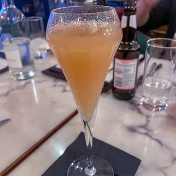 Flora Indica Chelsea - Guru Bellini - White Peach Purée, Homemade Rose Syrup, topped up with Prosecco - Bars Near Me - London, XGL Flora Indica Chelsea - Guru Bellini - White Peach Purée, Homemade Rose Syrup, topped up with Prosecco - Bars Near Me - London, XGL