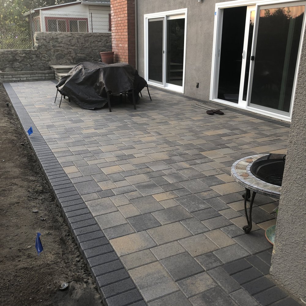 The new, finished patio with Angelus Courtyard pavers in dark grey/copper/charcoal (and charcoal border) with the wet seal. The new, finished patio with Angelus Courtyard pavers in dark grey/copper/charcoal (and charcoal border) with the wet seal.