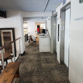 Arrive 800 Penn - A washing machine in the lobby. - Apartments Near Me - Denver, Colorado