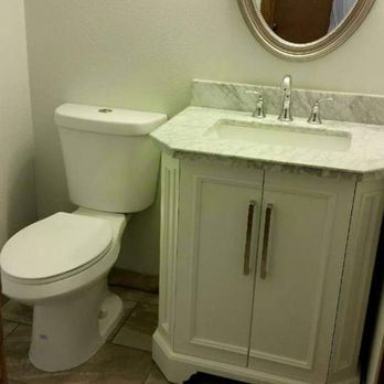 Leonic Collective - a bathroom with a toilet and sink - Roofing Near Me Leonic Collective - a bathroom with a toilet and sink - Roofing Near Me