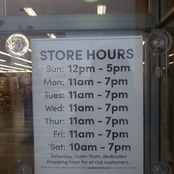 World Market - a store hours sign in a window - Furniture Stores Near Me - Lansing, Michigan World Market - a store hours sign in a window - Furniture Stores Near Me - Lansing, Michigan