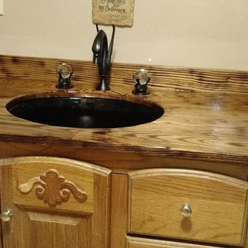 Wolf Pride - a bathroom sink with a wood counter top - General Contractors Near Me