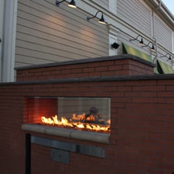 Wahlburgers - The fireplace in the outside dining area of Wahlburgers.