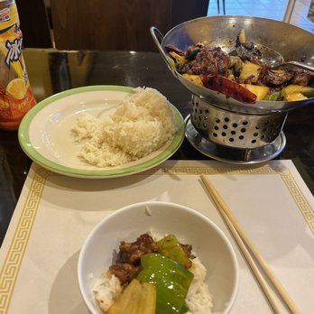 CoCo's Grill - A Chinese meal setup includes a plate of rice, a bowl with stir-fried beef and vegetables, and a can of beverage on a dark table. - Japanese Near Me - Columbus, Ohio