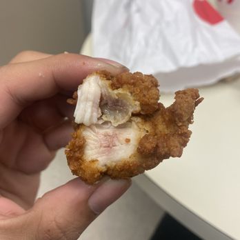 Chick-fil-A - ows a hand holding a piece of chicken - Fast Food Near Me - Stafford, Texas