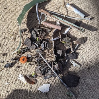 Eugene Gutter Service - different kinds of nails, shingle pieces, parts of siding, paint, and metal cylinders - Gutter Services Near Me - Eugene, Oregon