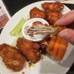 a plate of chicken wings and carrots a plate of chicken wings and carrots