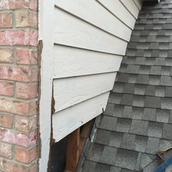Rain Leak Solutions - Water damaged siding caused by tree debris build-up in valley.