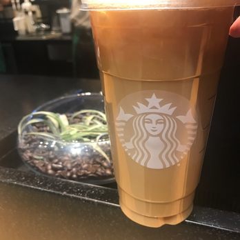 Starbucks - a hand holding a cup of coffee - Coffee & Tea Near Me - Newmarket, Ontario Starbucks - a hand holding a cup of coffee - Coffee & Tea Near Me - Newmarket, Ontario