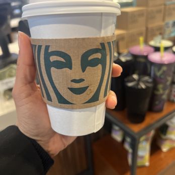Starbucks - a hand holding a cup of coffee - Coffee & Tea Near Me - St. Louis, Missouri Starbucks - a hand holding a cup of coffee - Coffee & Tea Near Me - St. Louis, Missouri