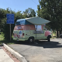 an ice cream van parked on the side of the road an ice cream van parked on the side of the road