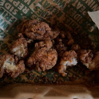 Wingstop - a closeup of a fried chicken in a wrapper - Chicken Wings Near Me - Coeur D Alene, Idaho Wingstop - a closeup of a fried chicken in a wrapper - Chicken Wings Near Me - Coeur D Alene, Idaho