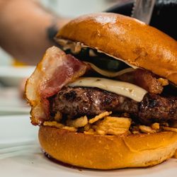 The Ravine on Sixteen - Gunslinger Burger. Burger made to order with Bacon, pepper jack cheese, chipotle mayo, whisky bbq & crispy onions