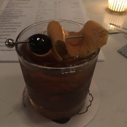 Excellent Old Fashioned served by a perfectly attentive bartender. Garnish beautifully done.