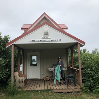 Halibut Cove Coffee House - a woman sitting on a porch - Cafes Near Me - Halibut Cove, Alaska Halibut Cove Coffee House - a woman sitting on a porch - Cafes Near Me - Halibut Cove, Alaska