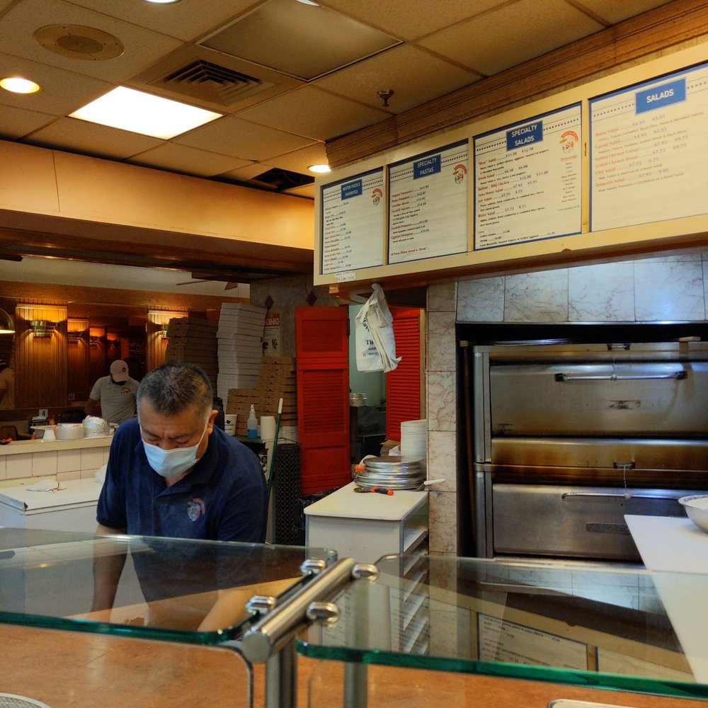 a man wearing a face mask in a restaurant a man wearing a face mask in a restaurant