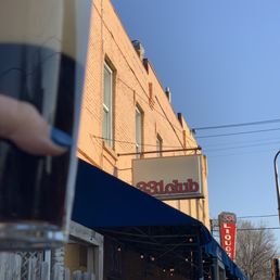 a hand holding a pint of guinness a hand holding a pint of guinness