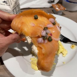 a person holding a piece of food a person holding a piece of food