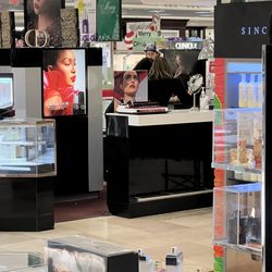 Dillard's - Uninterested sales people hovering over cell phone.
