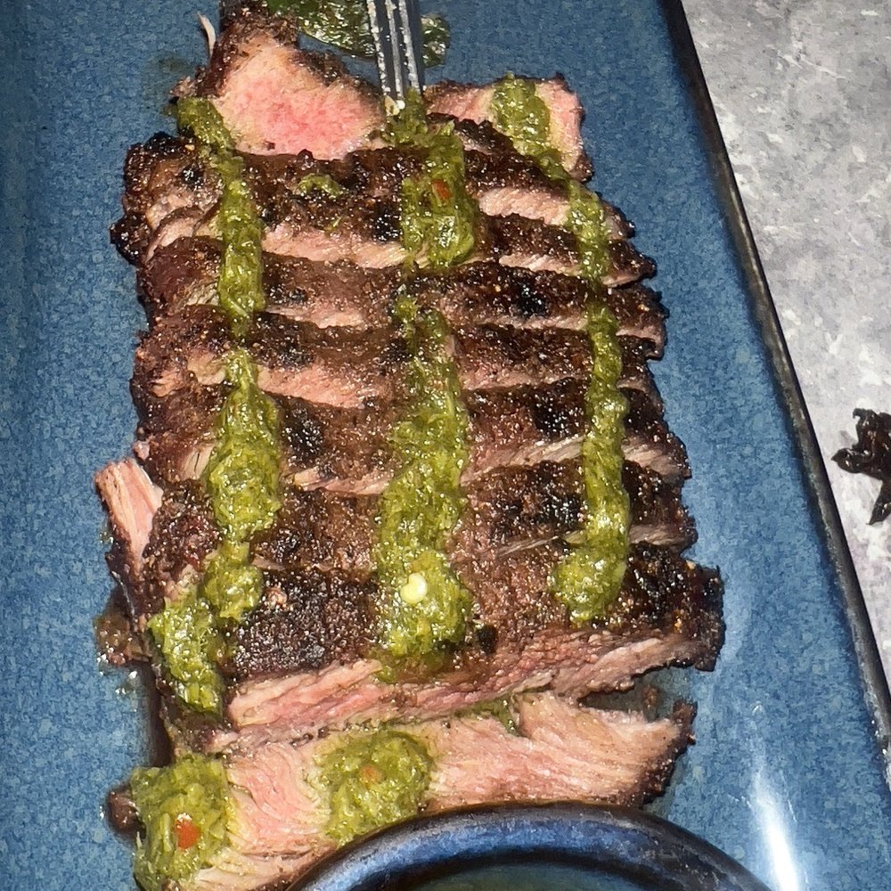 Mochuelo - Grilled Flank Steak with the extra side of the chimichurri - Tapas/Small Plates Near Me - Fresno, California Mochuelo - Grilled Flank Steak with the extra side of the chimichurri - Tapas/Small Plates Near Me - Fresno, California