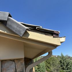 RED Plumbing - Damage to corner of my roof by the garage door caused by their tall work van.