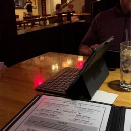 a man sitting at a table with a menu a man sitting at a table with a menu