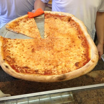 Amnon's Kosher Pizza - a man holding a pizza - Pizza Near Me - Brooklyn, New York Amnon's Kosher Pizza - a man holding a pizza - Pizza Near Me - Brooklyn, New York