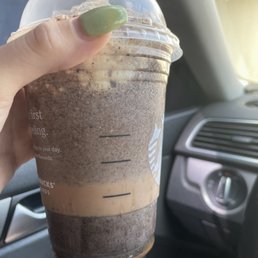 a hand holding a cup of coffee a hand holding a cup of coffee