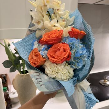 Wonder Blooms AZ - Floral bouquet with orange roses blue hydrangeas and orchid. Beautifully wrapped for gifting - Floral Designers Near Me - Tempe, Arizona Wonder Blooms AZ - Floral bouquet with orange roses blue hydrangeas and orchid. Beautifully wrapped for gifting - Floral Designers Near Me - Tempe, Arizona