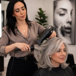 Master Stylist Kimia completes a customized women's haircut and professional blowout at Avissa Salon in Ann Arbor...