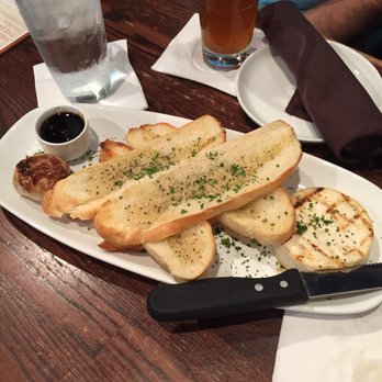 Biscottis - Grilled Brie with roasted garlic and sour cherry preserves ($10) - American Near Me - Jacksonville, Florida
