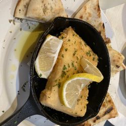 Fried cheese with lemon, olive oil, spices and pita