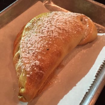 Sofrito Latin Cafe - Argentinian empanada with powdered sugar - Latin American Near Me - Orlando, Florida Sofrito Latin Cafe - Argentinian empanada with powdered sugar - Latin American Near Me - Orlando, Florida