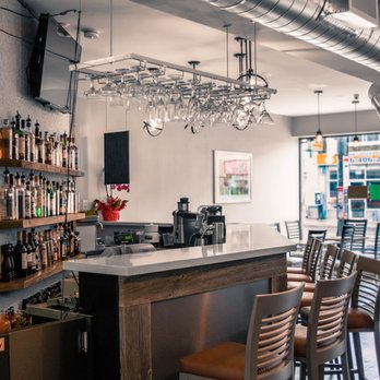 JP Restaurant - a bar with wine glasses hanging from the ceiling - Pubs Near Me - Toronto, Ontario