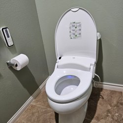 The Smile Memory bidet and remote control mounted on the wall.