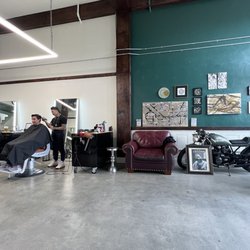 Braveheart Barbershop & Lifestyle - Sitting area and Boobi cutting hair