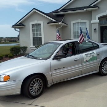 Michael's Lawn Care - a car parked in front of a house - Landscaping Near Me - St. Augustine, Florida Michael's Lawn Care - a car parked in front of a house - Landscaping Near Me - St. Augustine, Florida