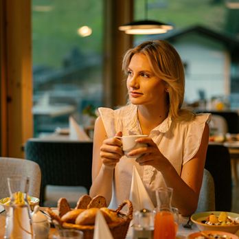 Evident Hotel Prägant ****S - Lady in restaurant having coffee and breakfast - Hotels Near Me - Bad Kleinkirchheim, 2 Evident Hotel Prägant ****S - Lady in restaurant having coffee and breakfast - Hotels Near Me - Bad Kleinkirchheim, 2