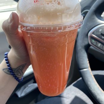 Paletería La Piña Loca - a person holding a drink in a car - Juice Bars & Smoothies Near Me - Bloomington, California