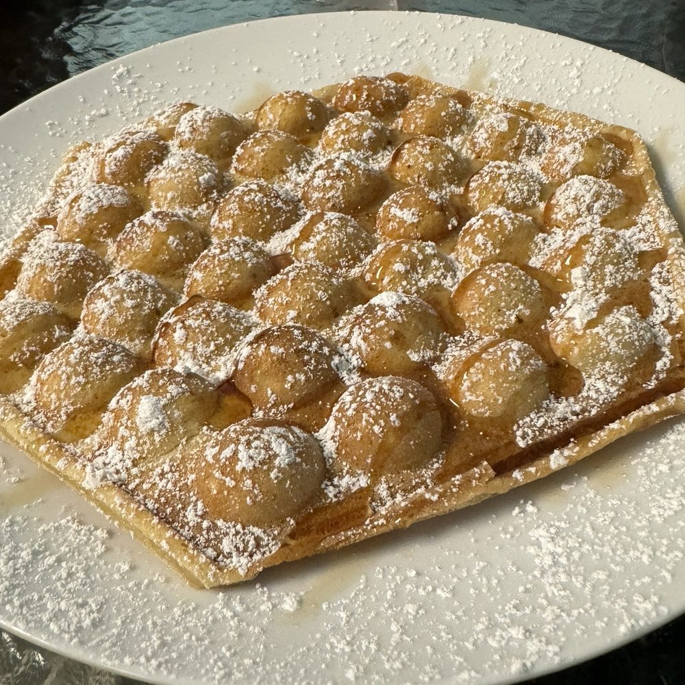Sweet Corner Cafe - Bubble waffle made to order and then drizzled with local honey. Fairly big dessert that our table shared. - Comfort Food Near Me - Aiea, Hawaii Sweet Corner Cafe - Bubble waffle made to order and then drizzled with local honey. Fairly big dessert that our table shared. - Comfort Food Near Me - Aiea, Hawaii